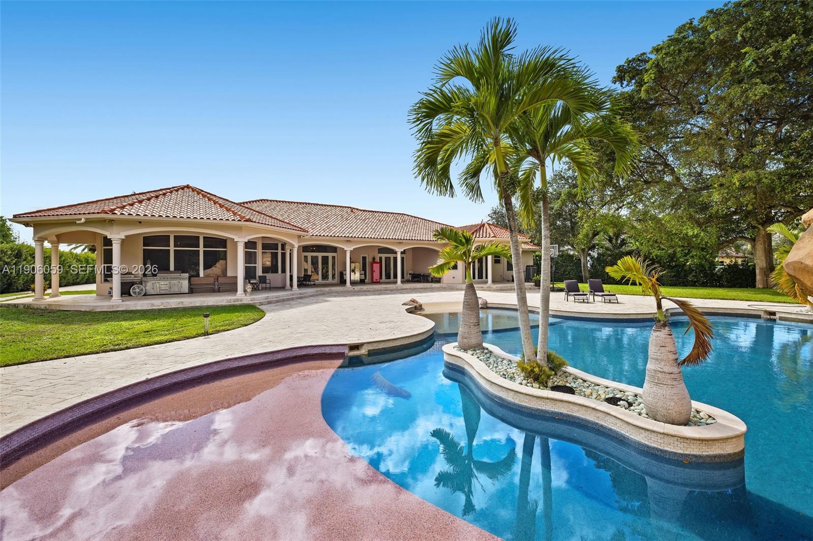 12175 Southwest 80th Street Miami, FL 33183 - Photo 38 of 56 a view of house with swimming pool outdoor seating