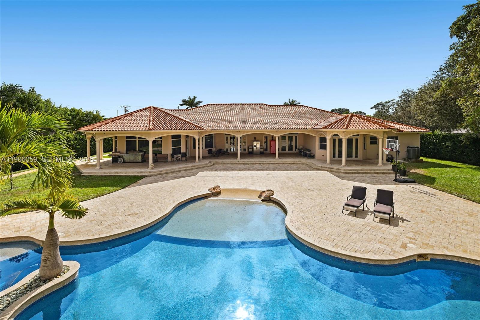 12175 Southwest 80th Street Miami, FL 33183 - Photo 39 of 56 a view of a house with pool and chairs