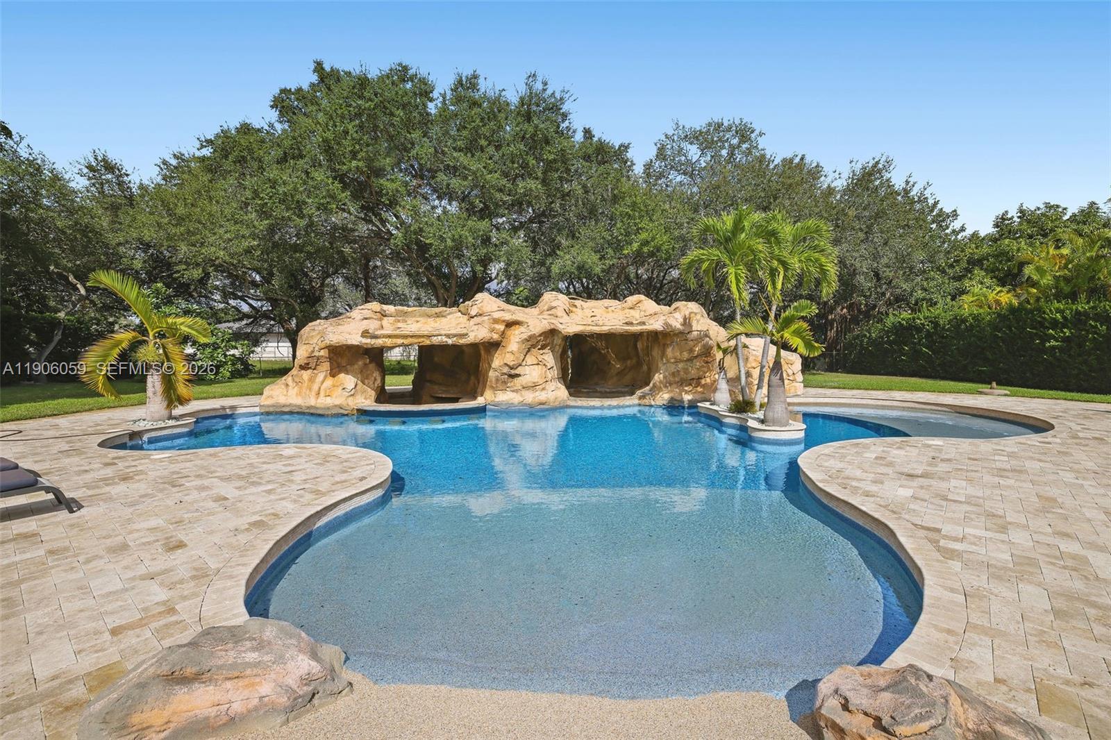 12175 Southwest 80th Street Miami, FL 33183 - Photo 41 of 56 a view of a swimming pool with a yard