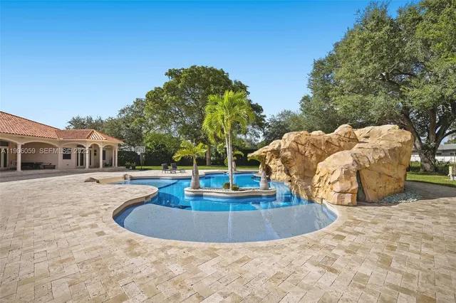 an aerial view of a house with a garden and lake view
