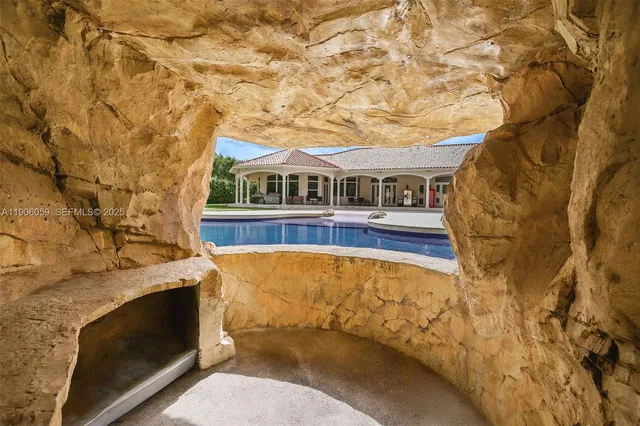 an aerial view of residential houses with outdoor space and trees