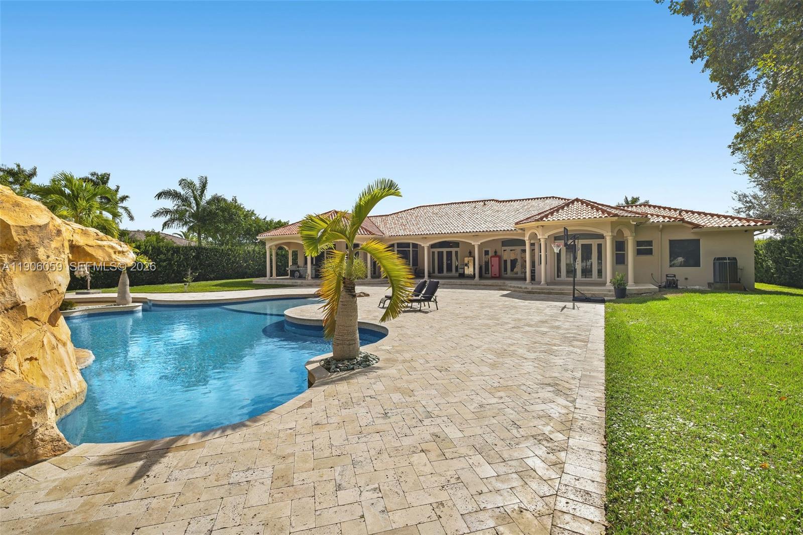 12175 Southwest 80th Street Miami, FL 33183 - Photo 48 of 56 a view of a house with pool and chairs