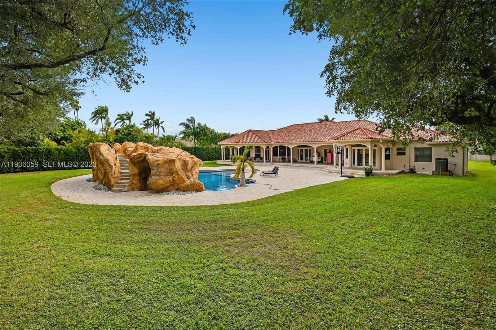 12175 Southwest 80th Street Miami, FL 33183 - Photo 49 of 56 a view of a house with a garden
