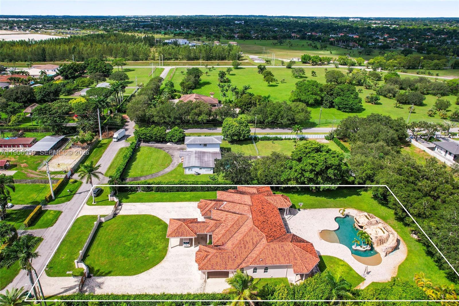 12175 Southwest 80th Street Miami, FL 33183 - Photo 55 of 56 an aerial view of a house with a garden and lake view