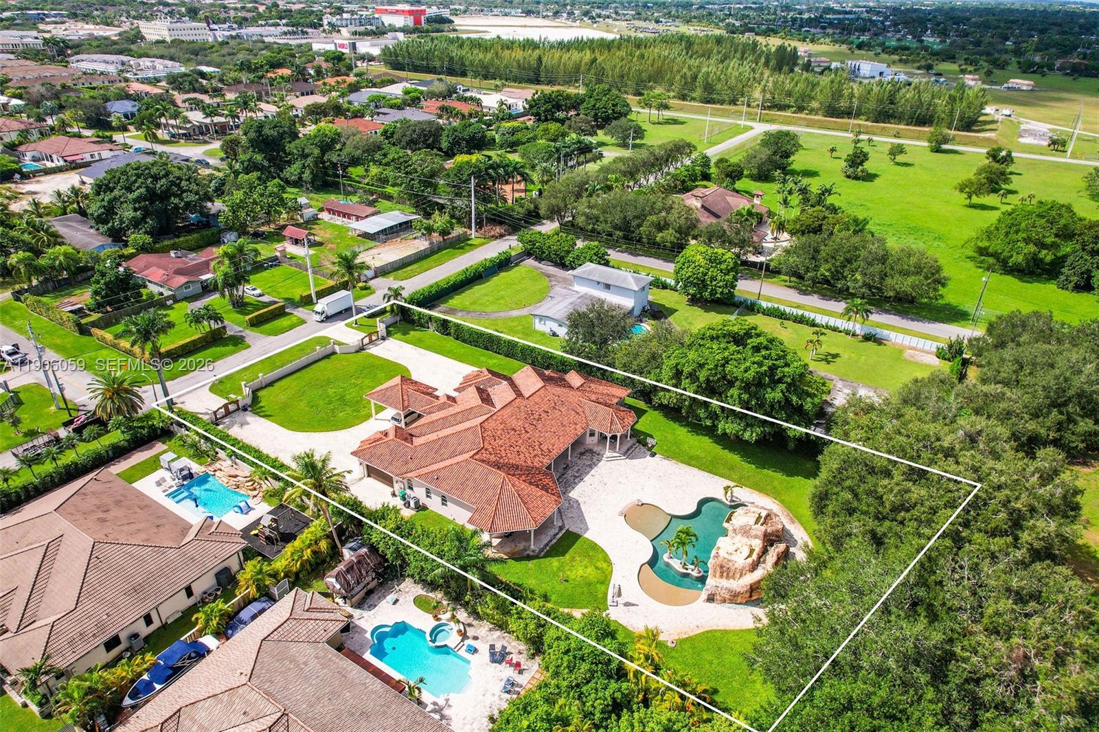 12175 Southwest 80th Street Miami, FL 33183 - Photo 56 of 56 an aerial view of a residential houses with outdoor space and a lake view