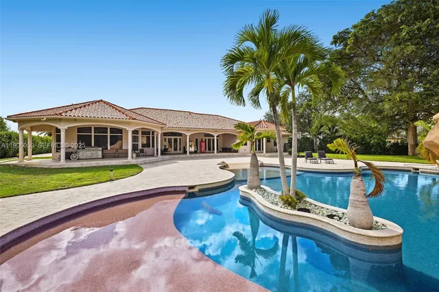 a view of house with swimming pool outdoor seating