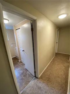 an entryway door with a hallway in the house