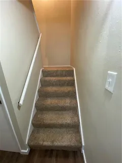 a view of staircase with white walls