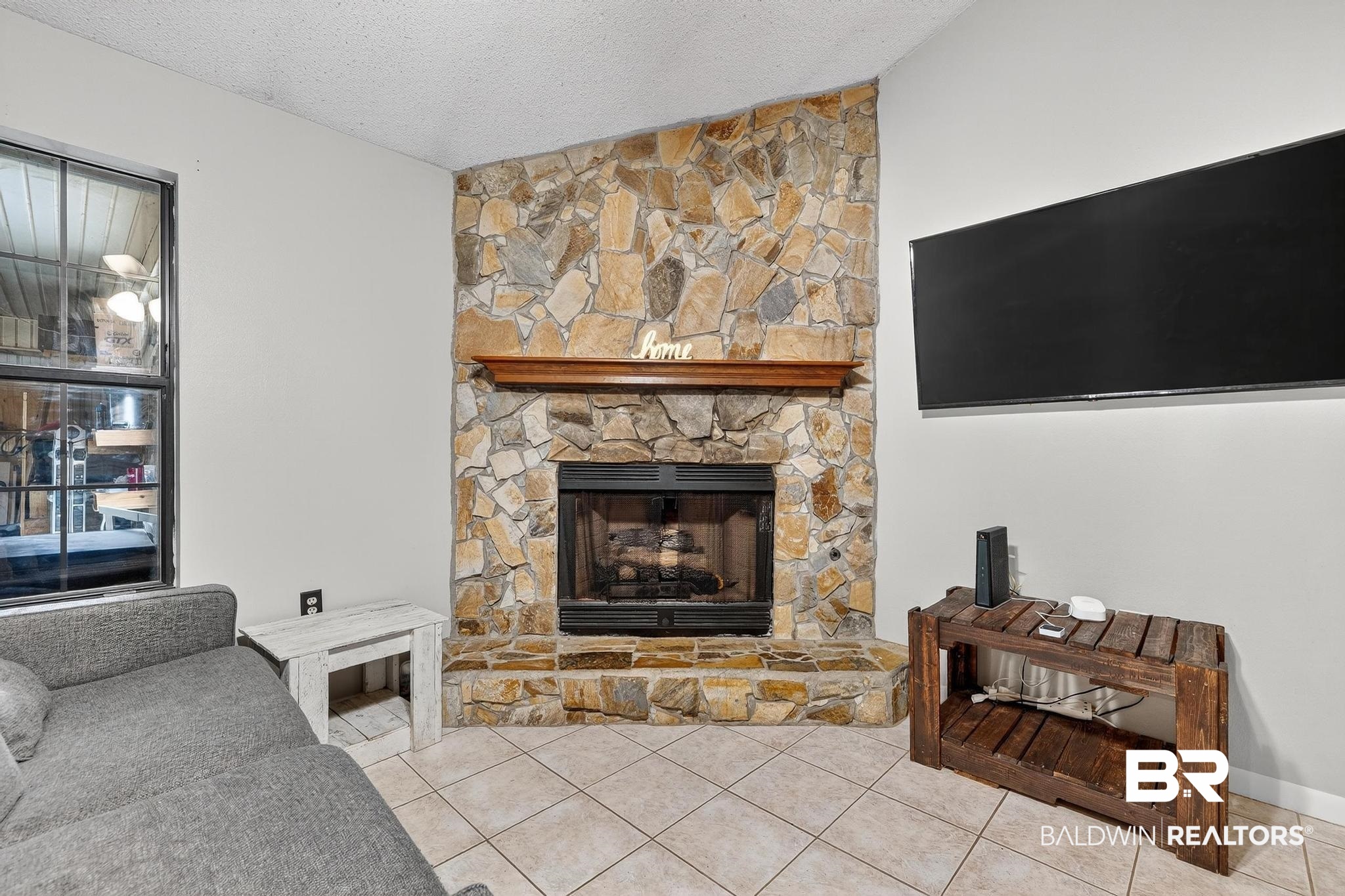 21895 2nd Street Silverhill, AL 36576 - Photo 17 of 43 Tiled living area with a fireplace and lofted ceiling