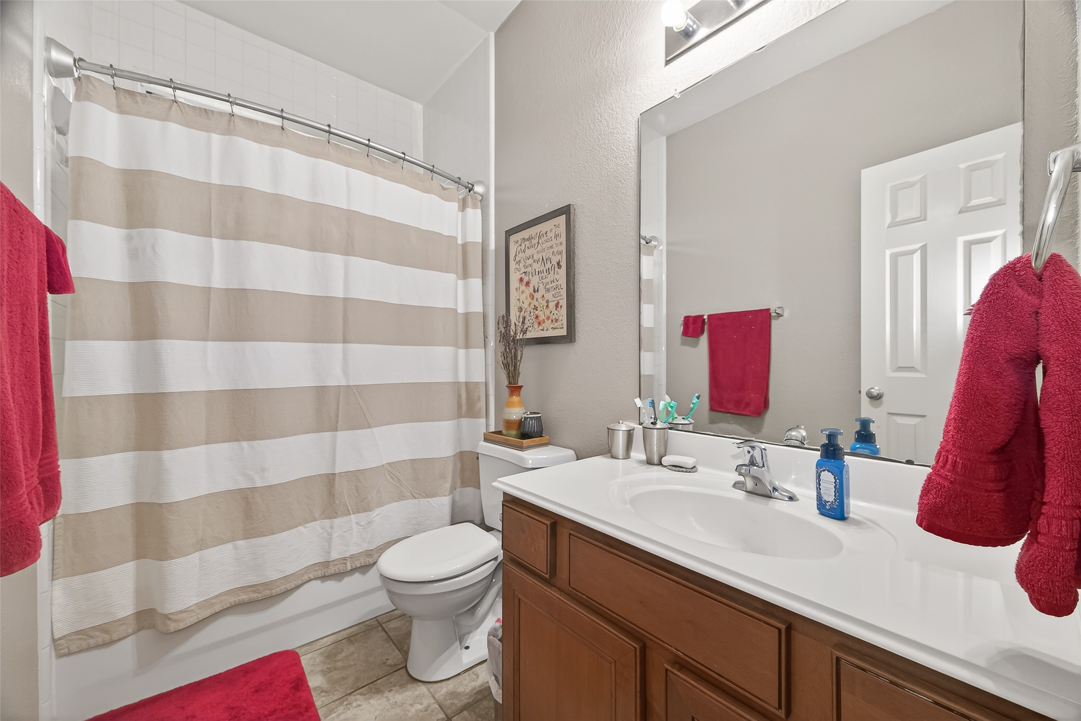 9110 Cavalier Lane Rosenberg, TX 77469 - Photo 19 of 30 The secondary bathroom is conveniently located near the secondary bedrooms and features a clean, modern design with a shower-tub combo.