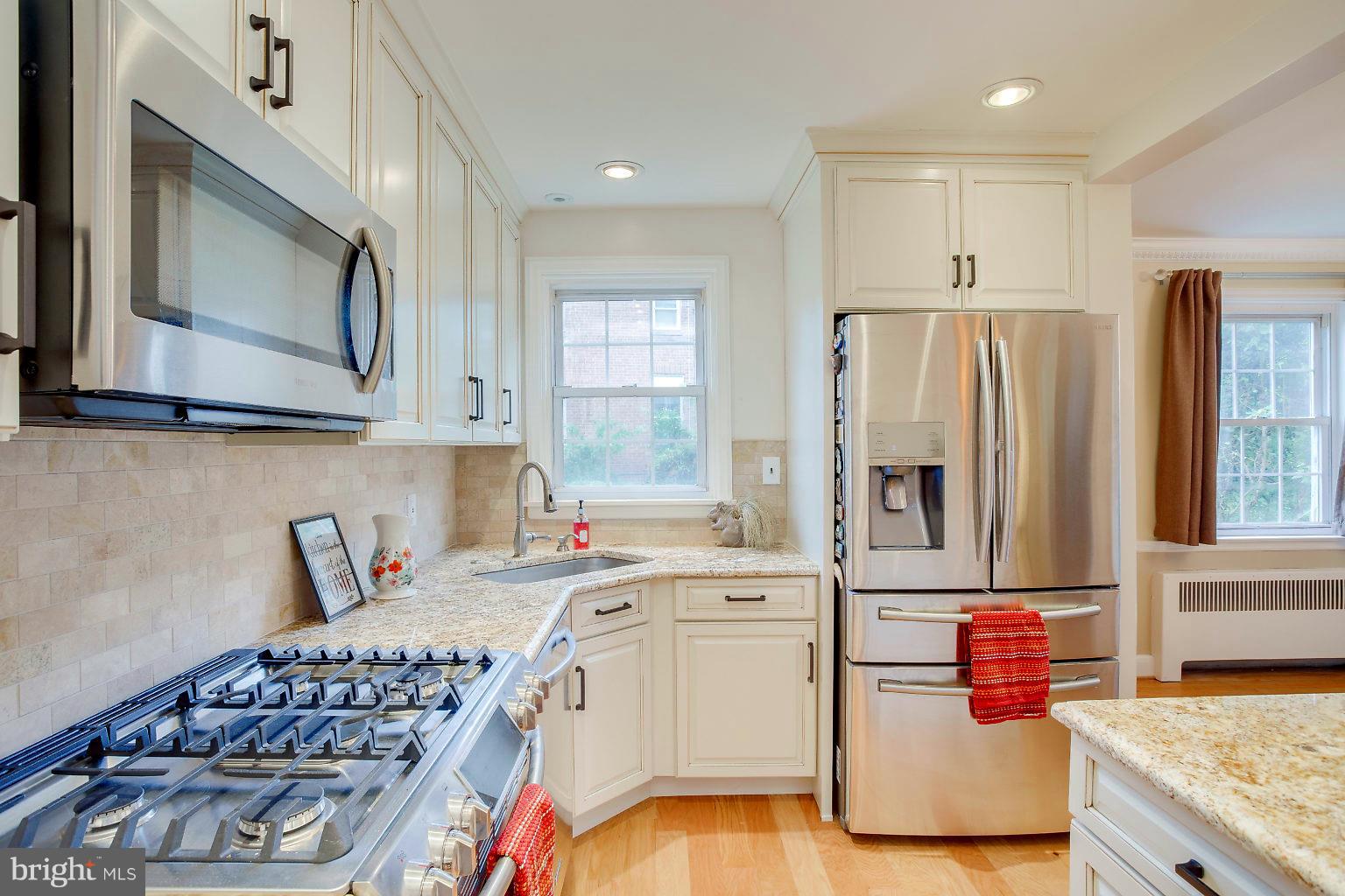 4208 Barrington Road Baltimore, MD 21229 - Photo 14 of 28 a kitchen with stainless steel appliances granite countertop a sink stove and refrigerator