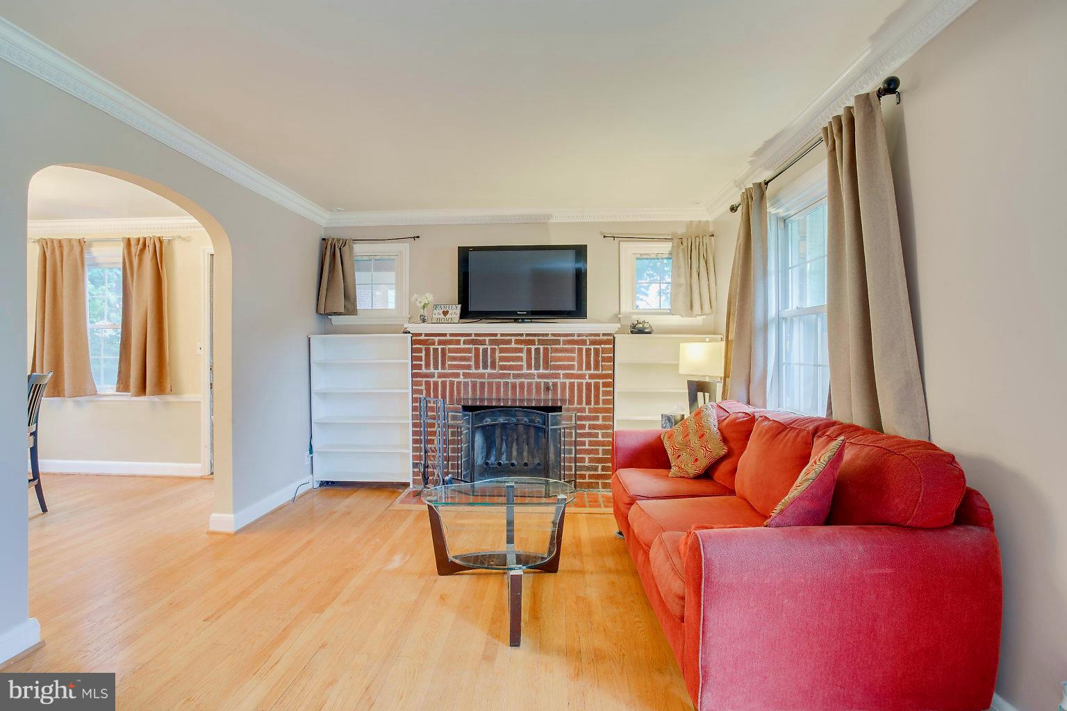 4208 Barrington Road Baltimore, MD 21229 - Photo 3 of 28 a living room with furniture and a fireplace