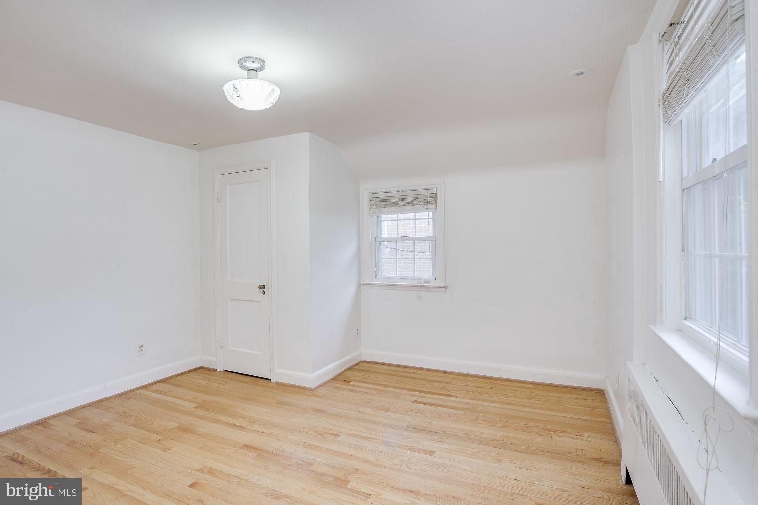 4208 Barrington Road Baltimore, MD 21229 - Photo 22 of 28 a view of empty room with wooden floor and fan