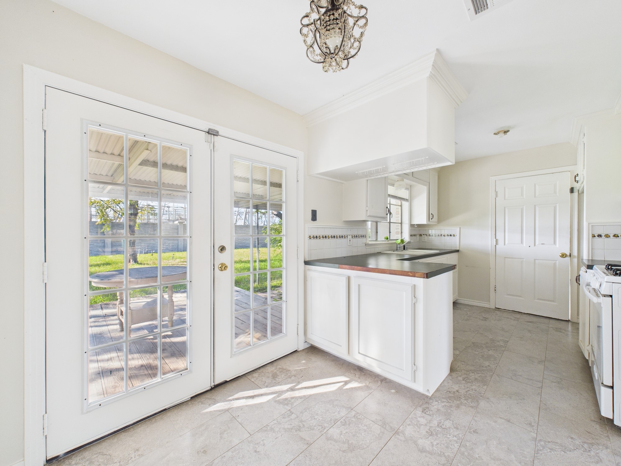 3035 Guese Road Houston, TX 77018 - Photo 7 of 20 a kitchen with stainless steel appliances granite countertop a refrigerator a sink a stove top oven a large window with white walls