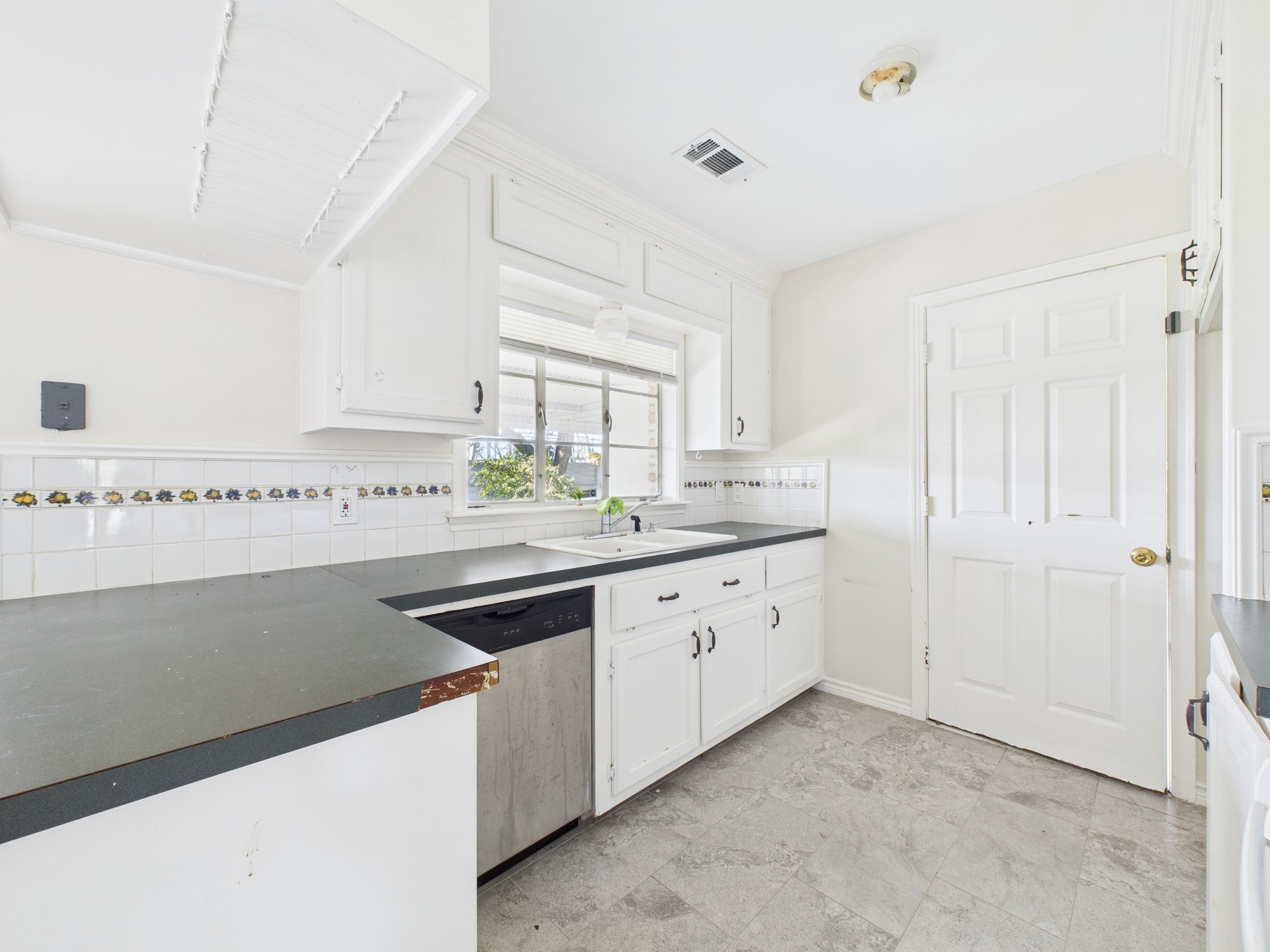3035 Guese Road Houston, TX 77018 - Photo 9 of 20 a kitchen with granite countertop white cabinets and white appliances