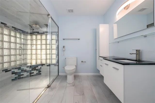a bathroom with a sink toilet and shower