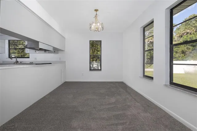 an empty room with windows and entrance