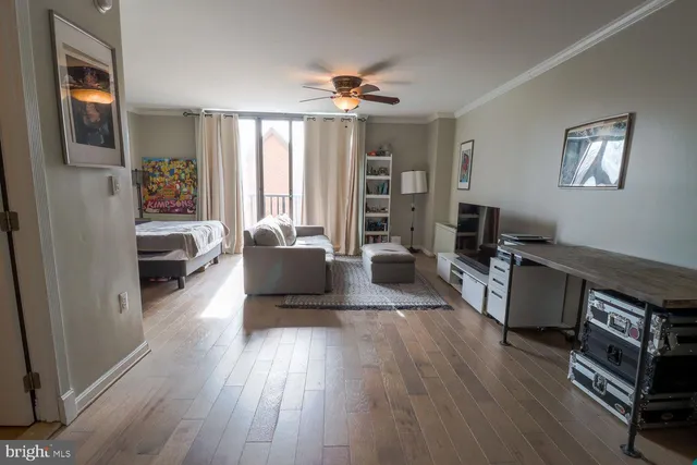a living room with furniture and a wooden floor