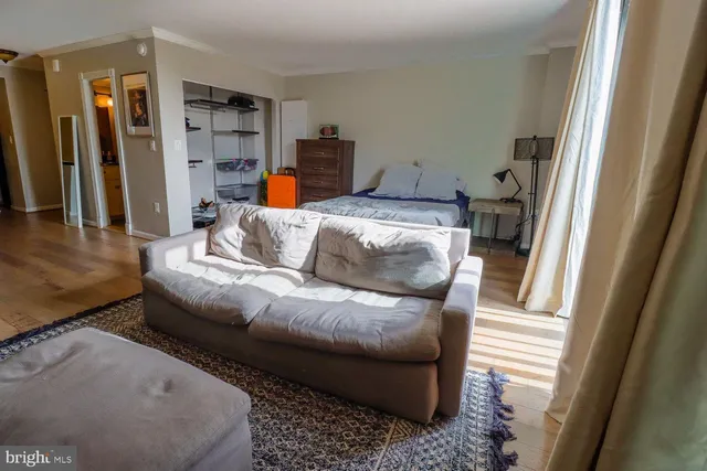 a living room with furniture and a walk in closet
