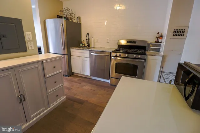 a kitchen with cabinets and white appliances