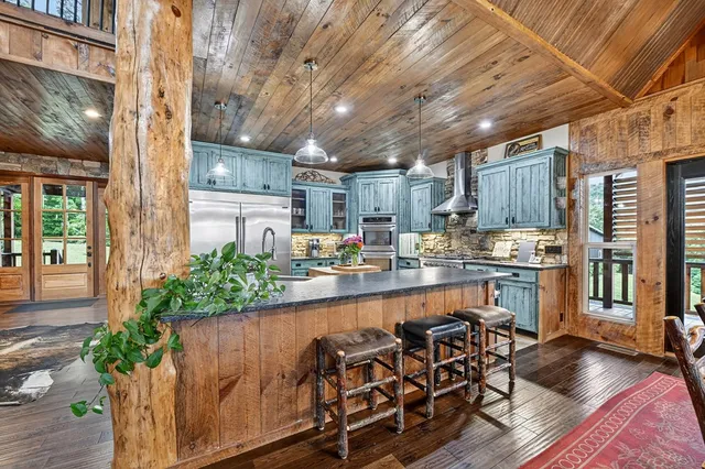 a kitchen with granite countertop stainless steel appliances and wooden cabinets