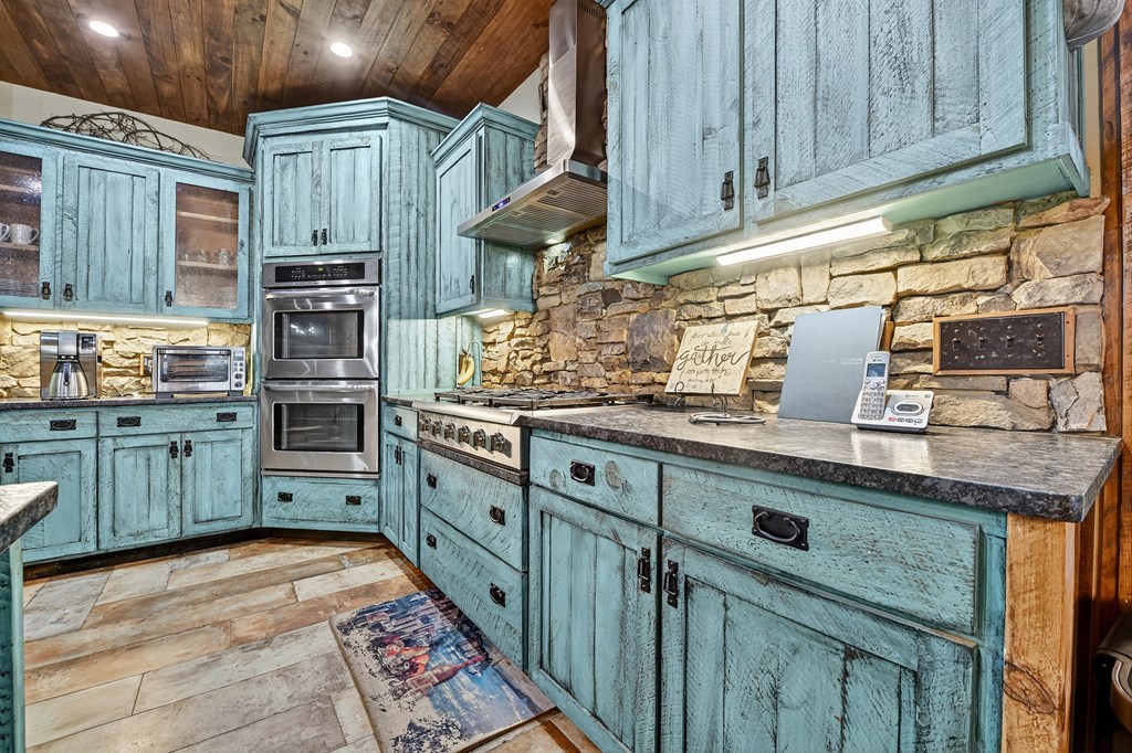 785 Wehunt Road Epworth, GA 30541 - Photo 13 of 73 a kitchen with stainless steel appliances granite countertop a sink a stove and cabinets