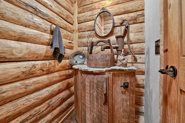 a bath tub sitting in a bathroom next to a window