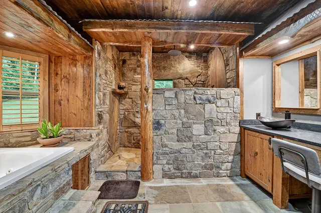 a bathroom with a granite countertop toilet sink and tub