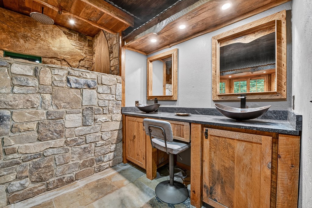 785 Wehunt Road Epworth, GA 30541 - Photo 25 of 73 a bathroom with a granite countertop sink and a mirror