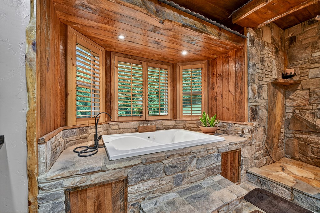 785 Wehunt Road Epworth, GA 30541 - Photo 27 of 73 a bath tub sitting in a bathroom next to a window
