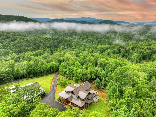 a living room with furniture a flat screen tv and a large window