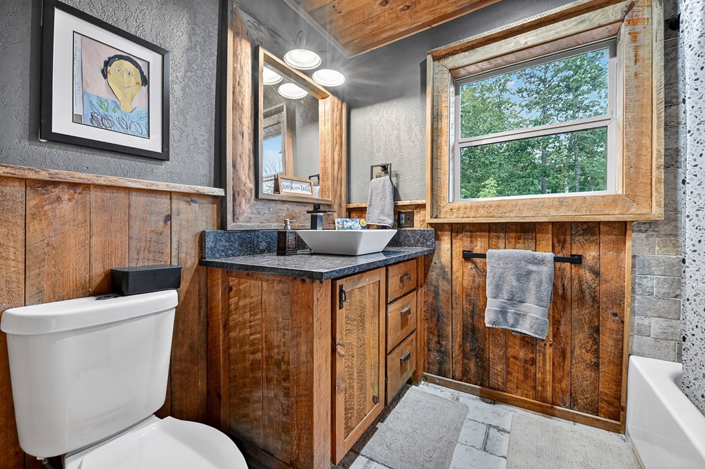 785 Wehunt Road Epworth, GA 30541 - Photo 31 of 73 a bathroom with a granite countertop toilet sink and tub