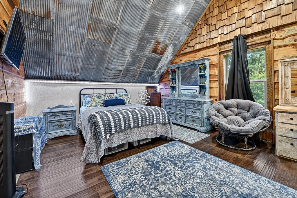 785 Wehunt Road Epworth, GA 30541 - Photo 32 of 73 a bedroom with furniture or couch and a fireplace