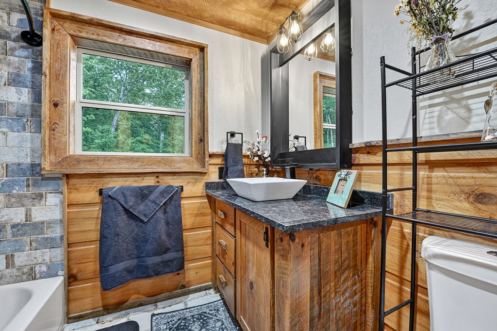 785 Wehunt Road Epworth, GA 30541 - Photo 33 of 73 a bathroom with a granite countertop sink and a window