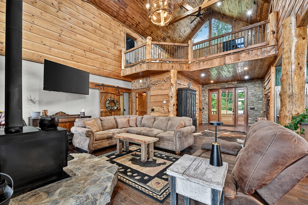 785 Wehunt Road Epworth, GA 30541 - Photo 8 of 73 a living room with furniture a flat screen tv and a fireplace