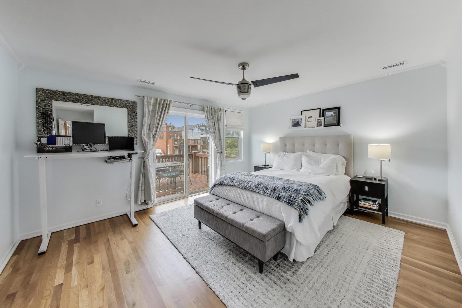 1862 North Halsted Street, Unit 3N Chicago, IL 60614 - Photo 13 of 25 a spacious bedroom with a bed and a flat screen tv