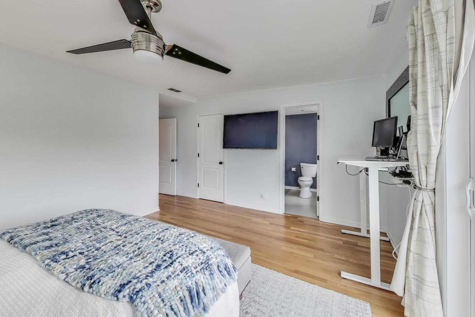 1862 North Halsted Street, Unit 3N Chicago, IL 60614 - Photo 14 of 25 a bedroom with a bed and a flat tv screen on the dresser