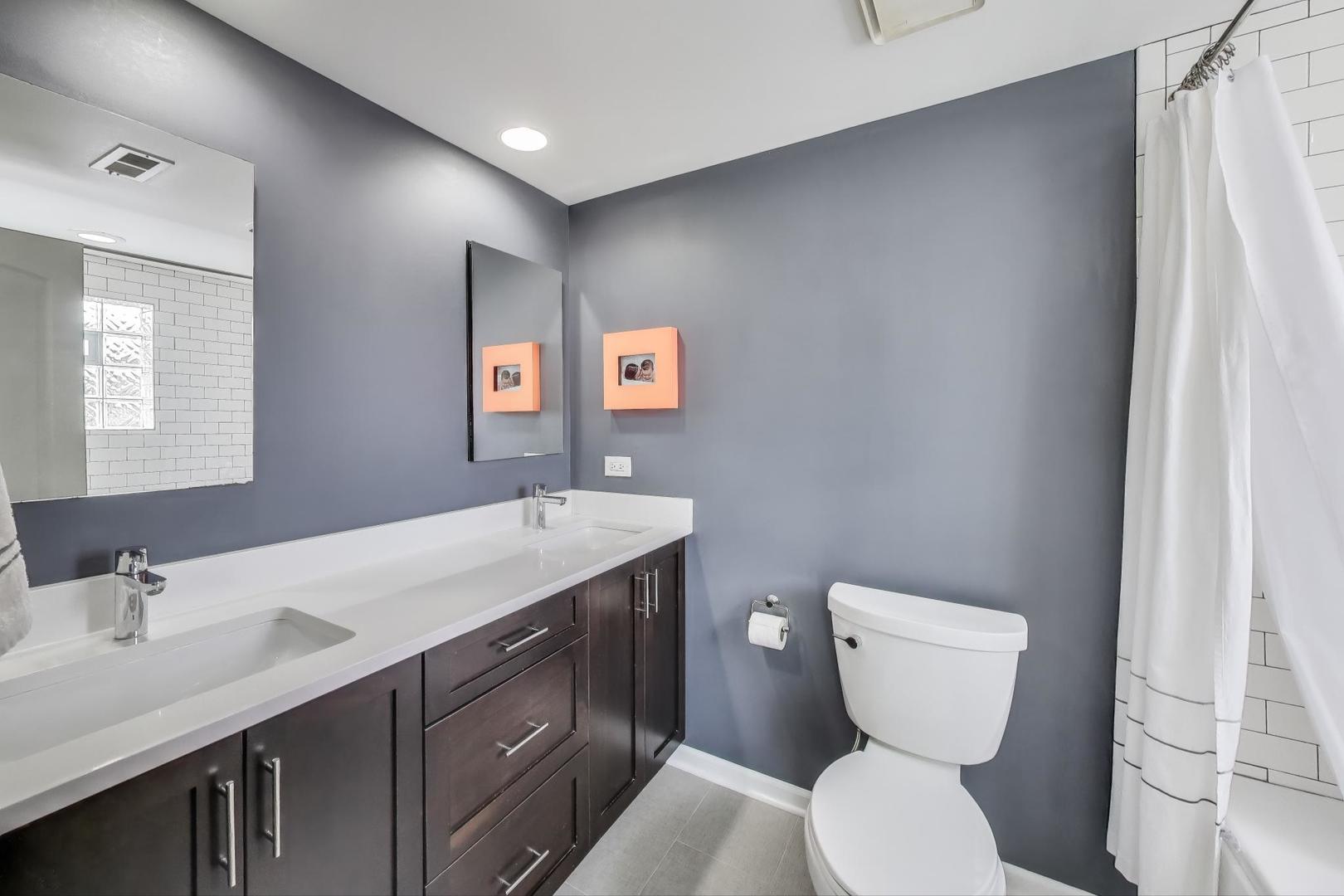 1862 North Halsted Street, Unit 3N Chicago, IL 60614 - Photo 15 of 25 a bathroom with a toilet sink and mirror