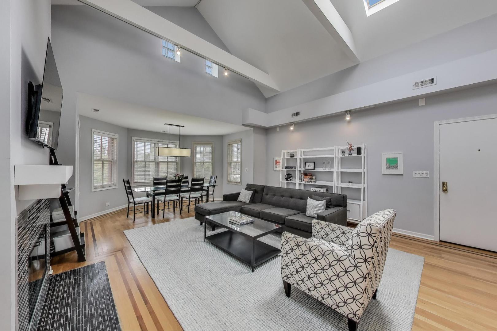 1862 North Halsted Street, Unit 3N Chicago, IL 60614 - Photo 2 of 25 a living room with furniture and a wooden floor