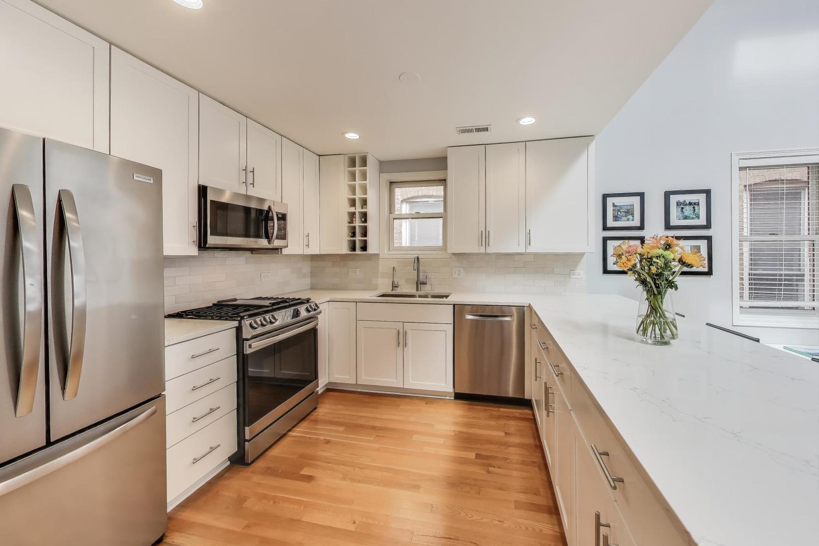 1862 North Halsted Street, Unit 3N Chicago, IL 60614 - Photo 7 of 25 a kitchen with stainless steel appliances granite countertop a refrigerator a stove top oven a sink and dishwasher