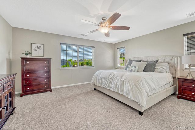a spacious bedroom with a bed and a chandelier