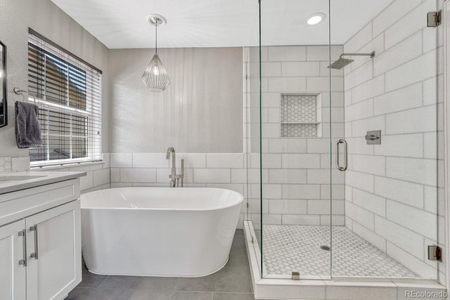 a white bath tub sitting next to a white sink