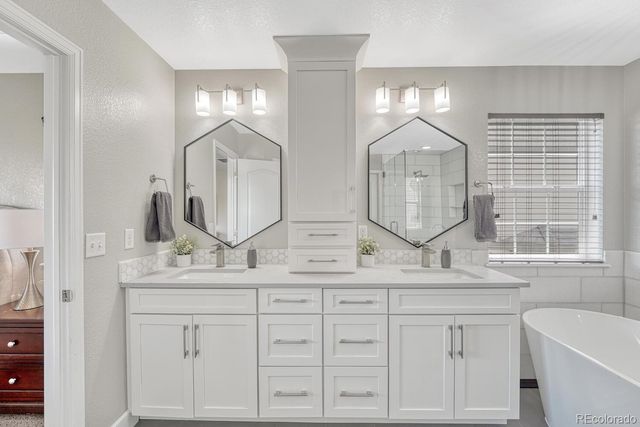 a bathroom with double vanity and a mirror