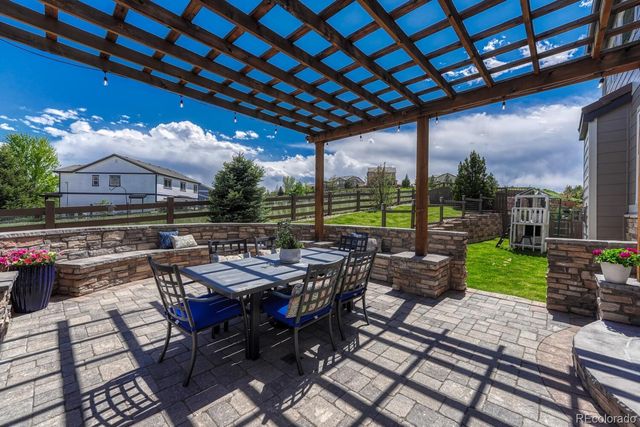 a view of a patio with a table and chairs