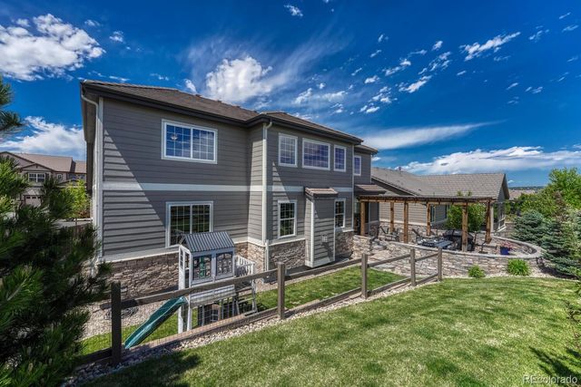 a front view of house with a garden and patio