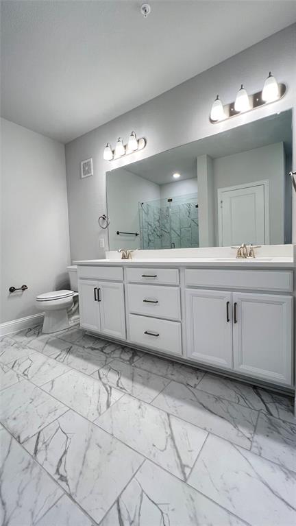 651 Watters Road, Unit 3300 Allen, TX 75013 - Photo 16 of 25 Bathroom featuring vanity, toilet, an enclosed shower, and a textured ceiling