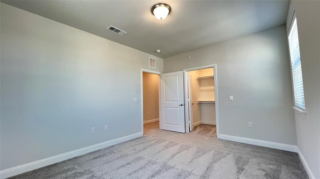 651 Watters Road, Unit 3300 Allen, TX 75013 - Photo 19 of 25 Unfurnished bedroom with a closet, light colored carpet, and a spacious closet
