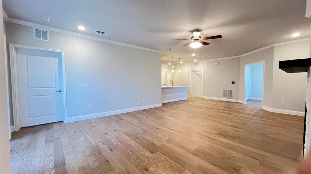651 Watters Road, Unit 3300 Allen, TX 75013 - Photo 7 of 25 Empty room with ceiling fan, ornamental molding, and light hardwood / wood-style floors