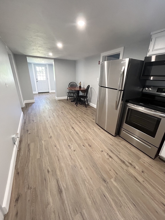 13 Maranook Road Worcester, MA 01606 - Photo 11 of 24 a view of a refrigerator in kitchen and wooden floor
