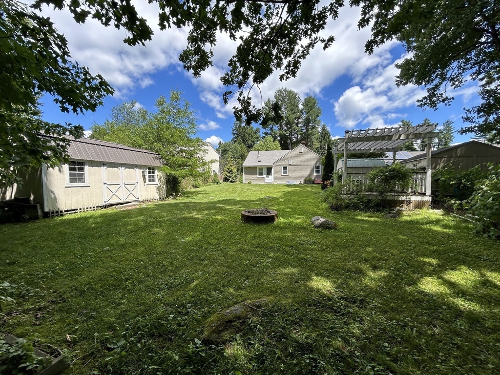 13 Maranook Road Worcester, MA 01606 - Photo 22 of 24 a view of a backyard with table and chairs and a large tree